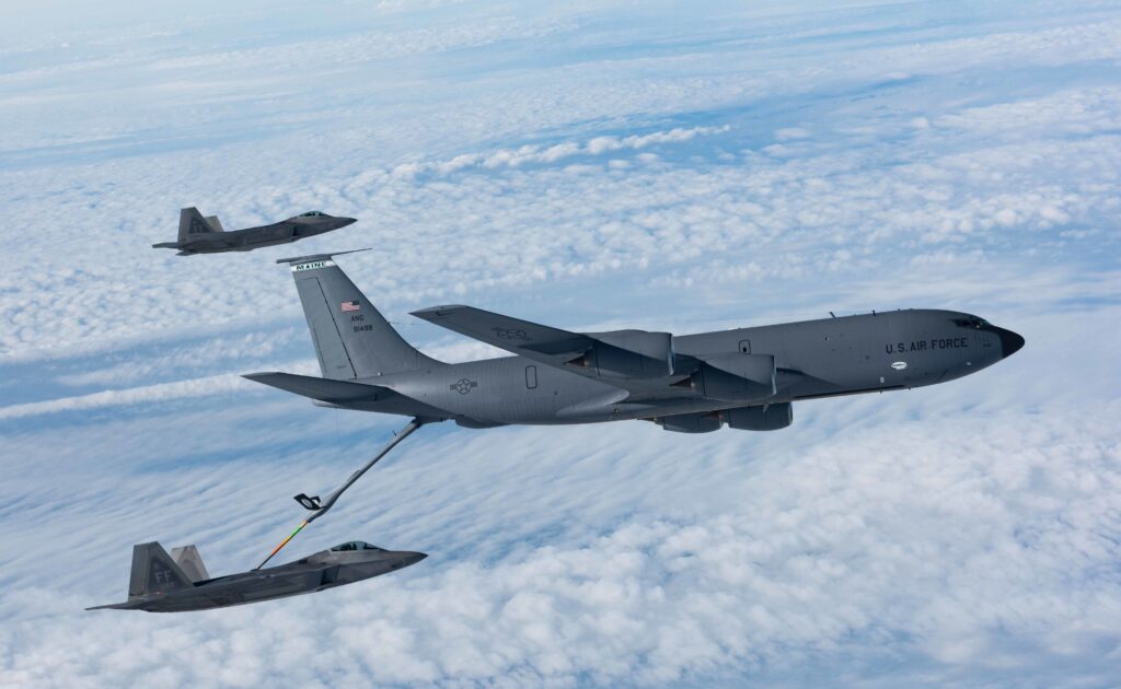 KC-135 Stratotanker refuels F-22 Raptors. Aerial refueling, tanker aircraft.